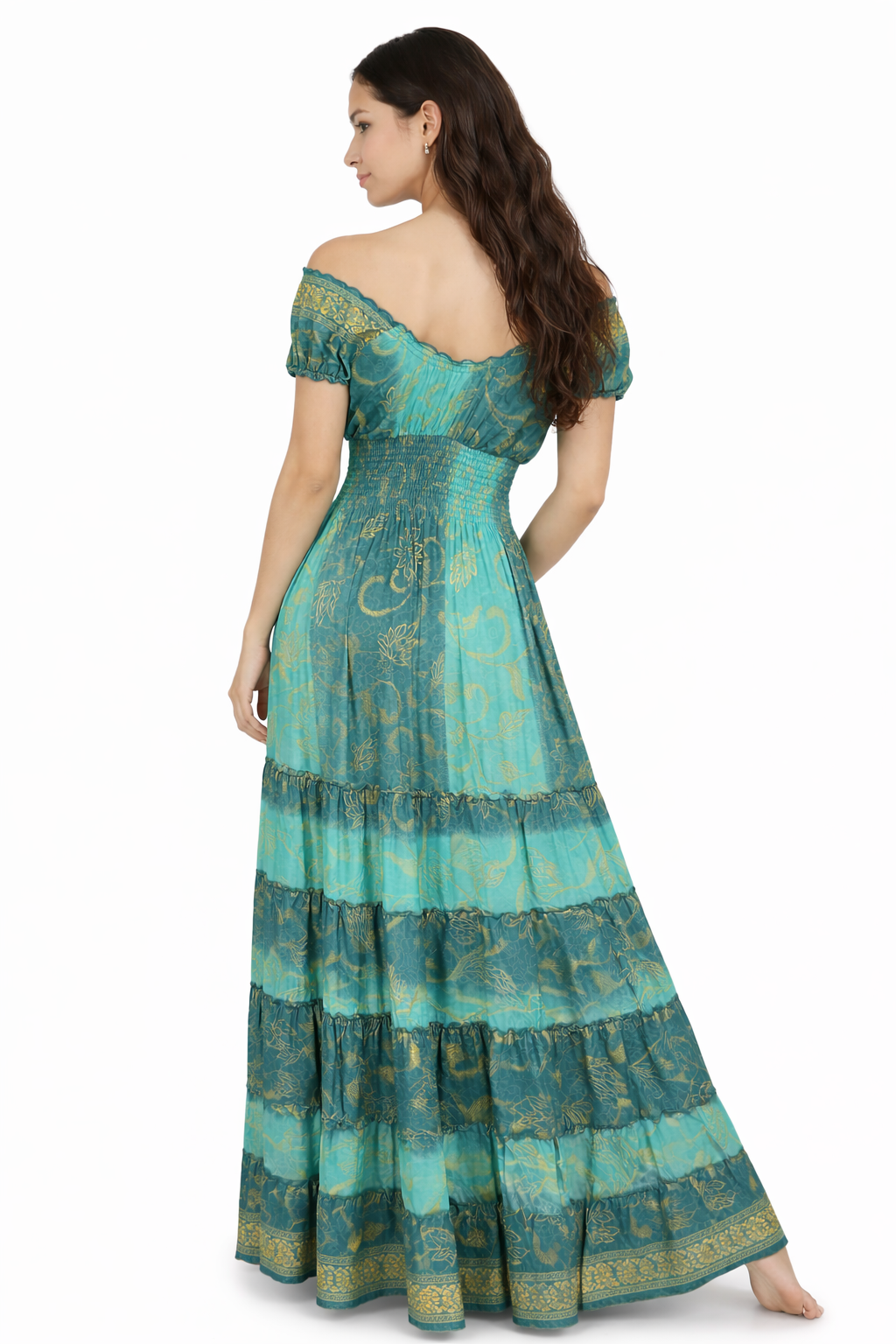 Woman wearing a teal off-shoulder dress with intricate patterns on a white background
