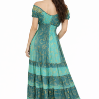 Woman wearing a teal off-shoulder dress with intricate patterns on a white background