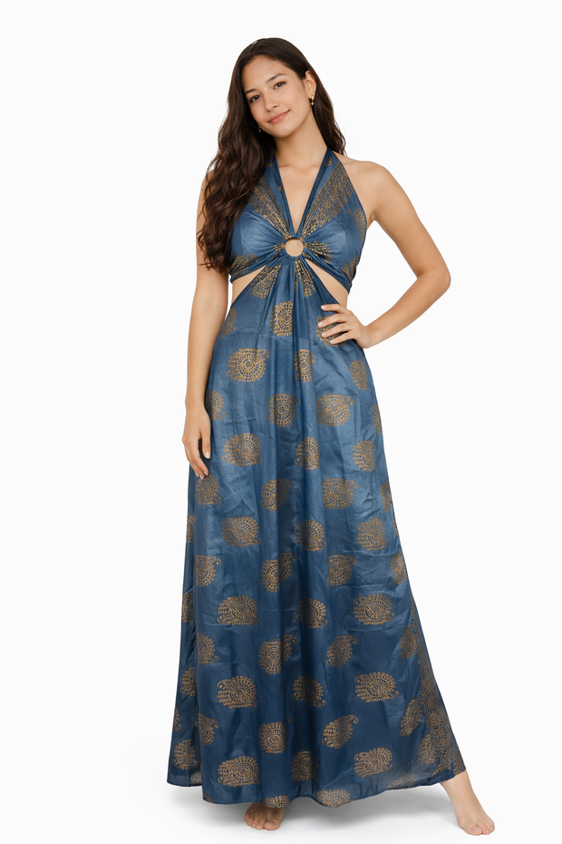 Woman wearing a blue and gold patterned halter neck dress on a white background