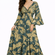 Woman wearing a long floral dress on a white background