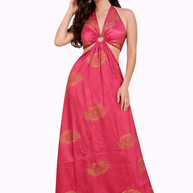 Woman wearing a pink halter neck dress with gold patterns on a white background