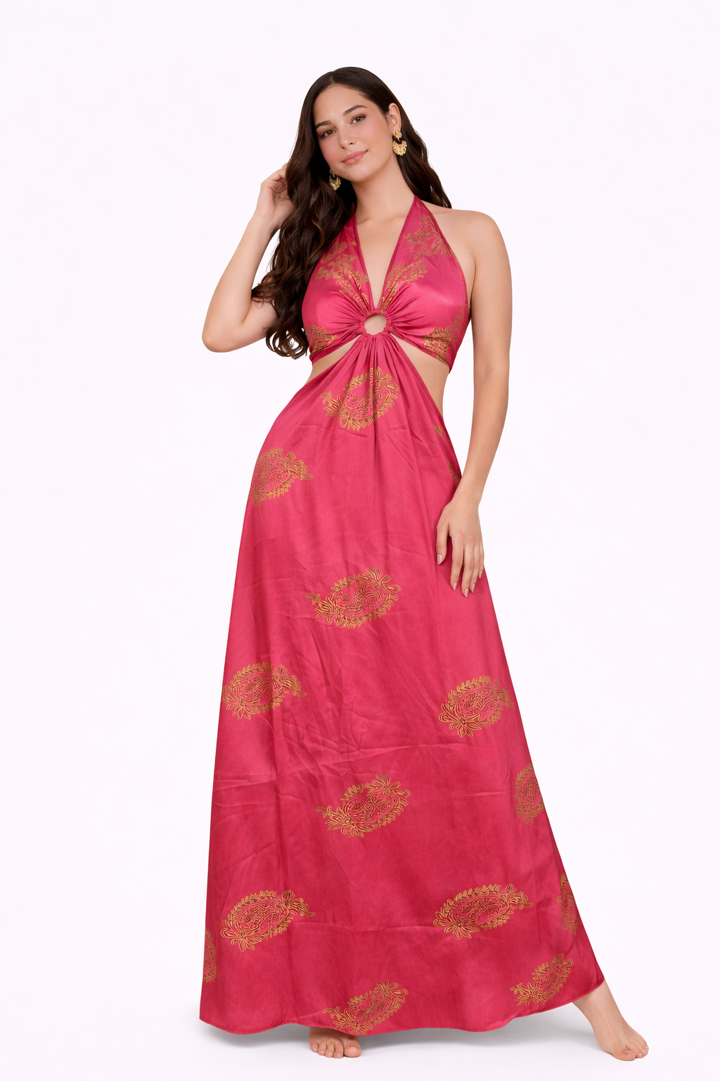 Woman wearing a pink halter neck dress with gold patterns on a white background