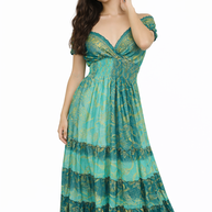 Woman wearing a green patterned dress on a white background