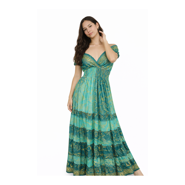 Woman wearing a green patterned dress on a white background